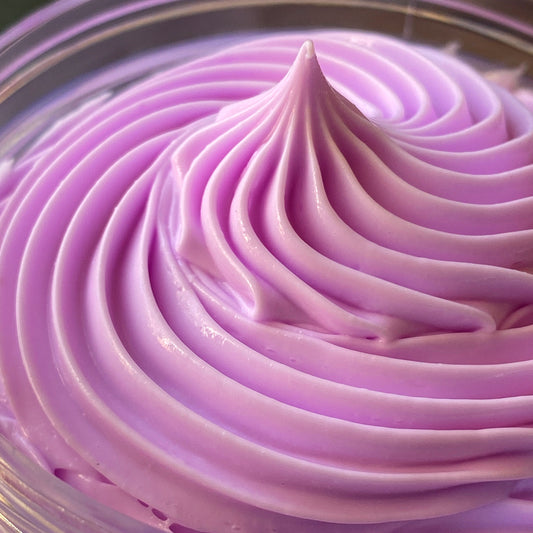 up close shot of piped body butter in  jar