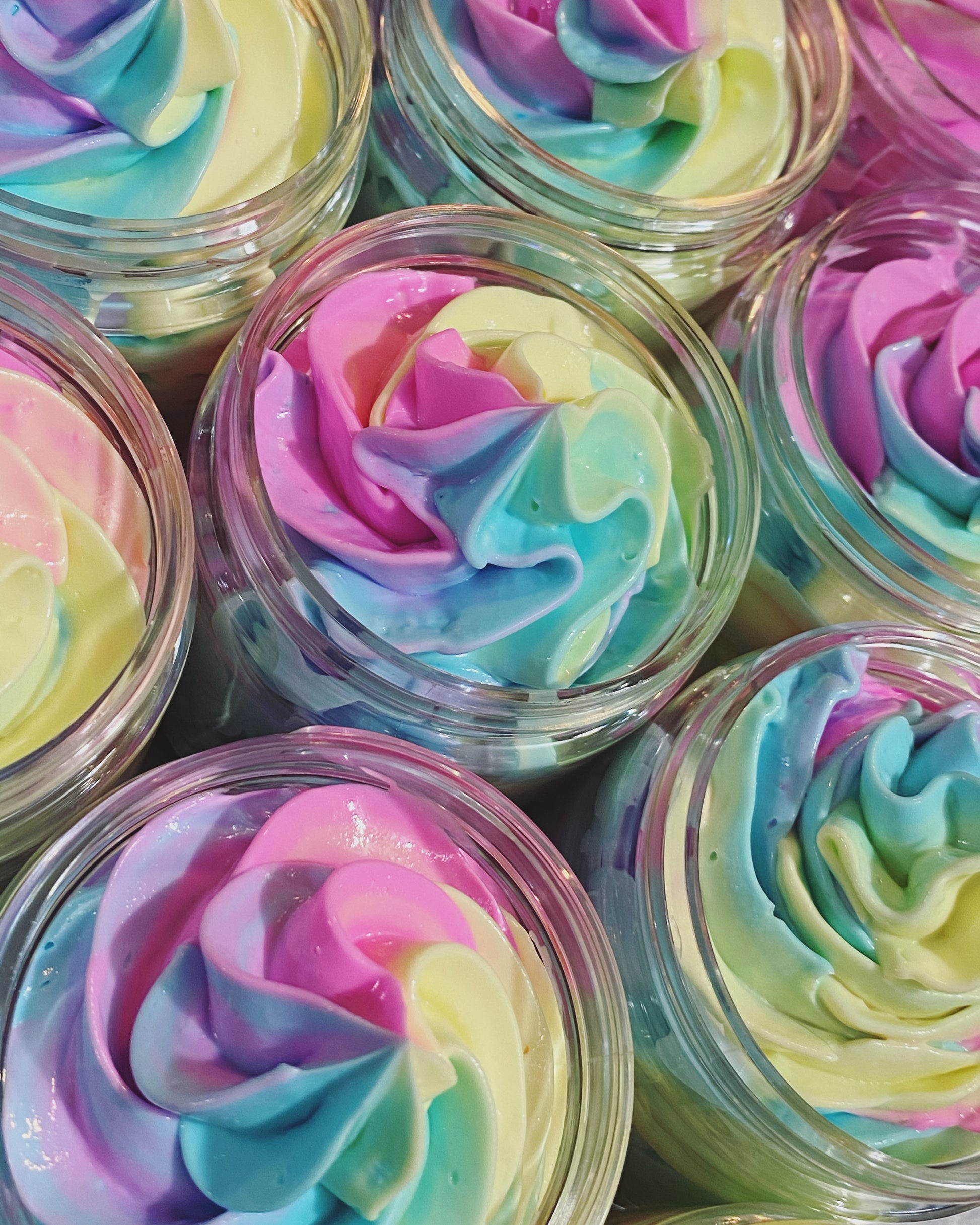 multiple jars of rainbow colored body butter